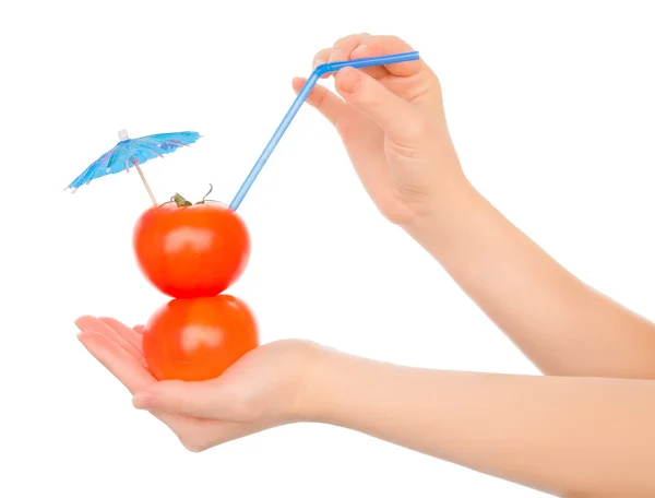 Two tomatos with straw and cocktail umbrella — Stock Photo, Image