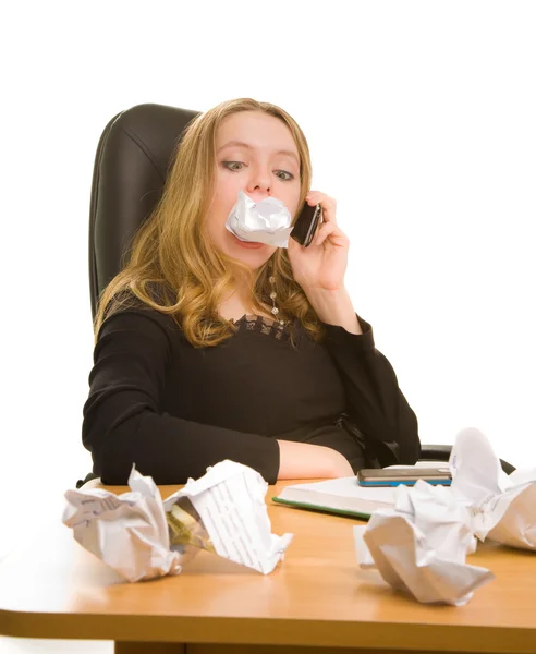 Businesswoman with sheet of paper in her mouth — Stock Photo, Image