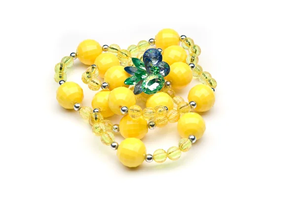Yellow beads with colorful ring — Stock Photo, Image
