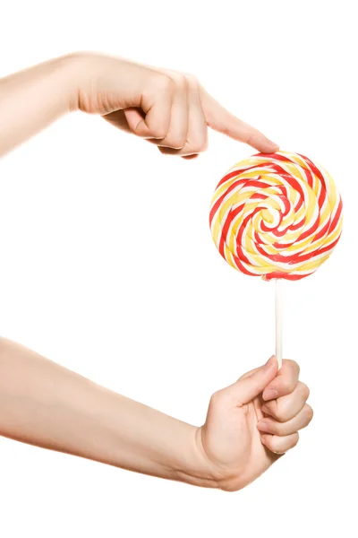 Woman's hands with lollipop — Stock Photo, Image