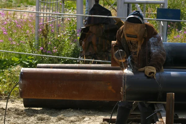 Stock image Man welding the pipe