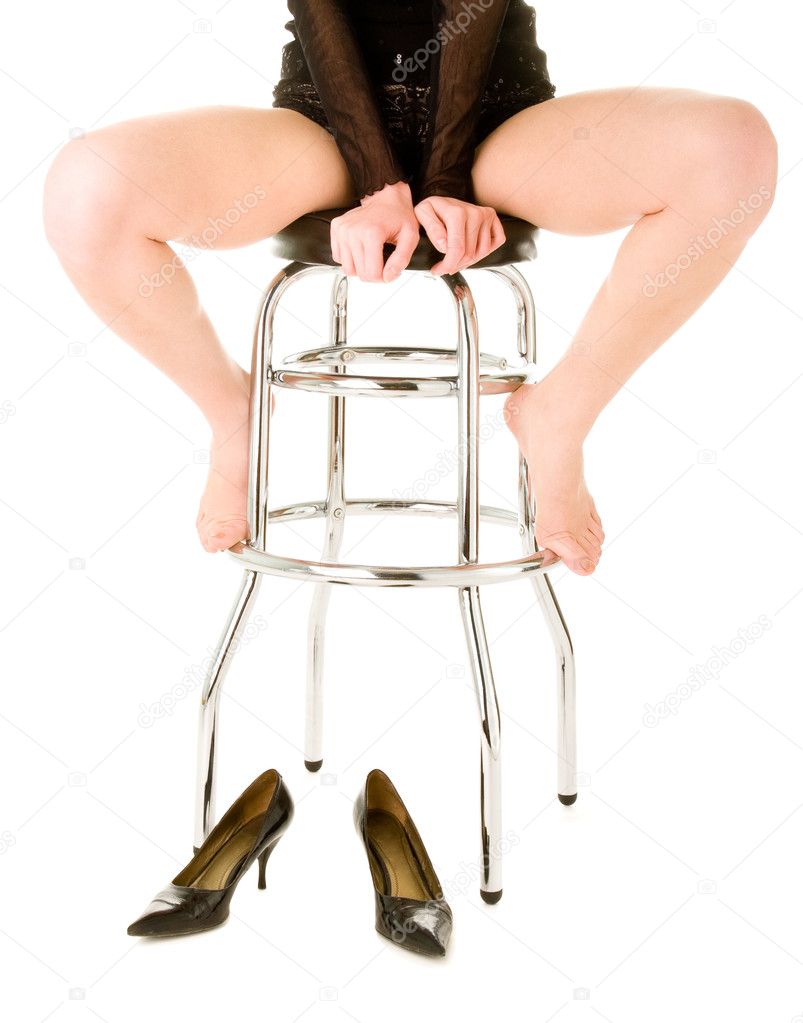 Barefoot woman sitting on the barchair