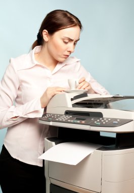 Angry businesswoman with copier and cup of coffee clipart