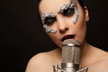 Gothic singer standing with microphone clipart