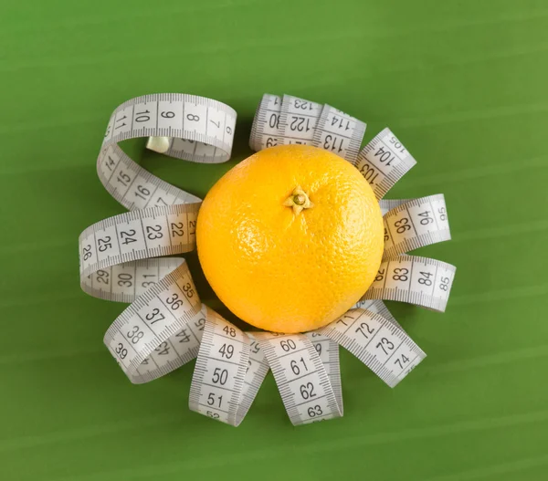 Orange and measure tape — Stock Photo, Image