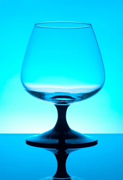 Brandy glass isolated on blue background — Stock Photo, Image