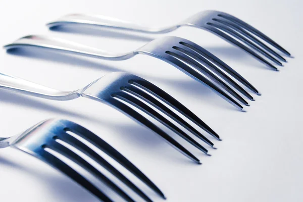 Several forks on a white background — Stock Photo, Image