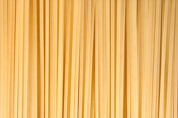 Raw pasta as whole background — Stock Photo, Image