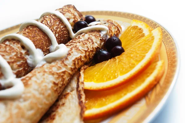 Rolled pancakes with berries and sour cream — Stock Photo, Image