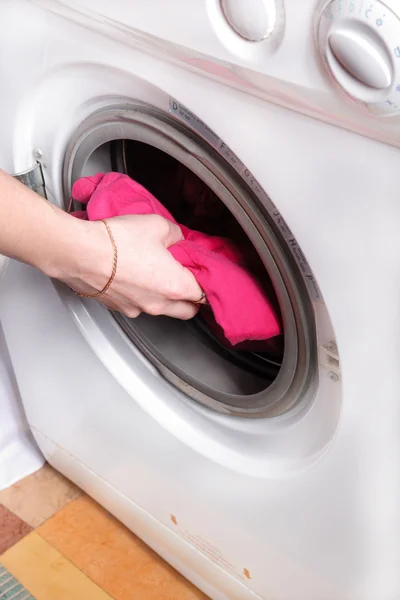 Woman's hand puts the laundry — Stock Photo, Image
