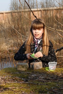 Teen Girl Recording Geocaching logbook clipart