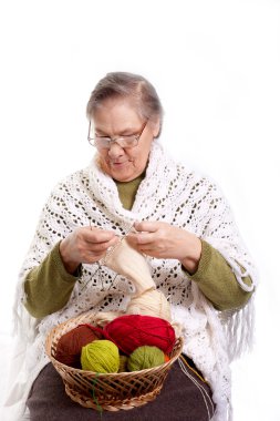 Senior woman knitting clipart