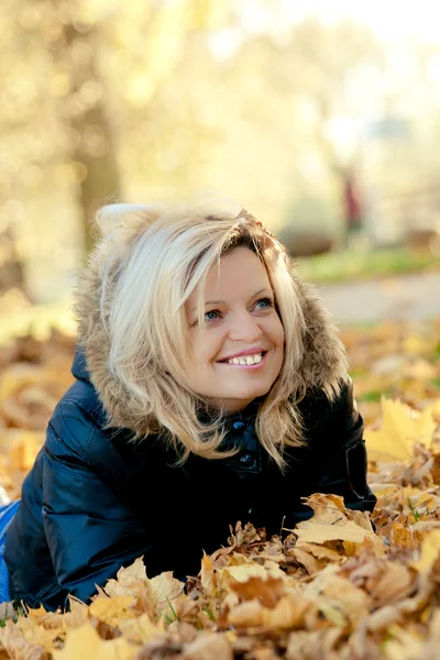 stock image Woman lying in autumn leaves