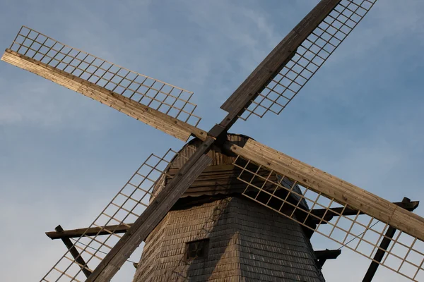 stock image Old wooden windmill wings against blue sky