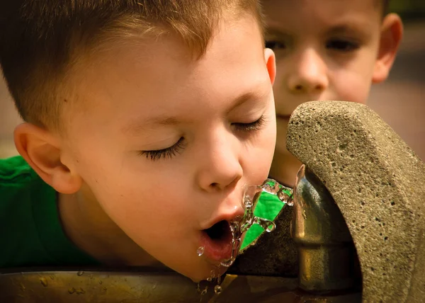 stock image Boy drinking from fountain