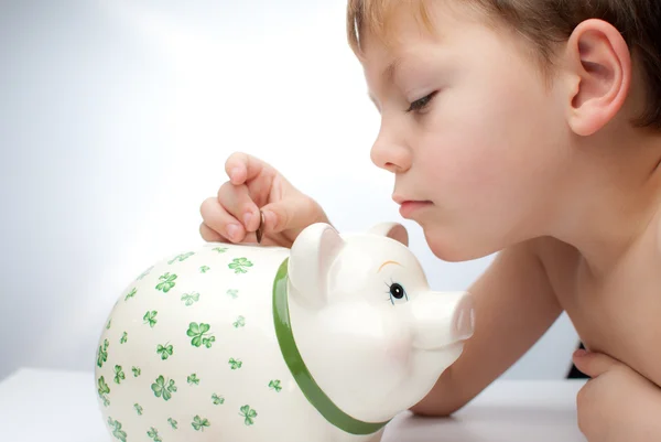 Kid with a piggy bank — Stock Photo, Image