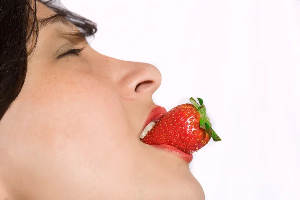 Tasty Woman with strawberry in mouth — Stock Photo, Image