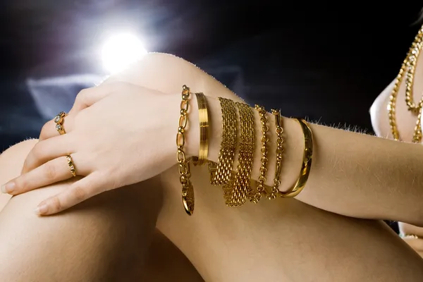 Close-up de modelo com muitas jóias de ouro — Fotografia de Stock
