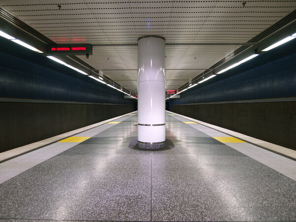 A empty but colorful modern subway platform.