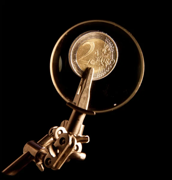 stock image Euro coins under magnifying glass