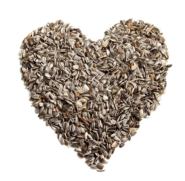Fond de graines de tournesol en forme de cœur . — Photo