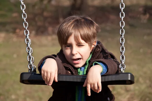 Portrait of a boy on a swing — Stock Photo, Image