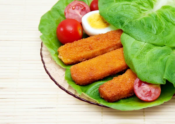 Fish sticks with egg salad on a platter. — Stock Photo, Image