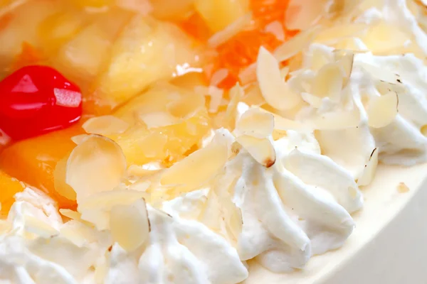 Fruit cake with whipped cream — Stock Photo, Image