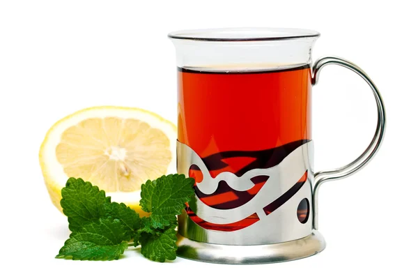 Tea in a glass holder and a sprig of lemon balm — Stock Photo, Image