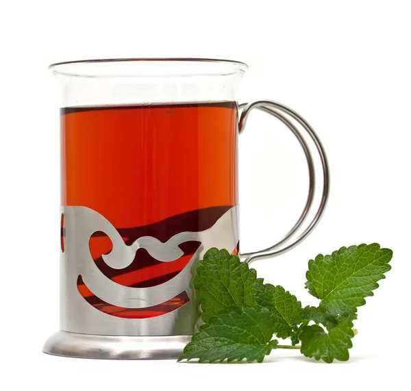 Herbata w uchwyt do szkła i gałązką melisy — Zdjęcie stockowe