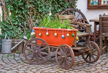 Old wagon with flowers. Homestead. clipart