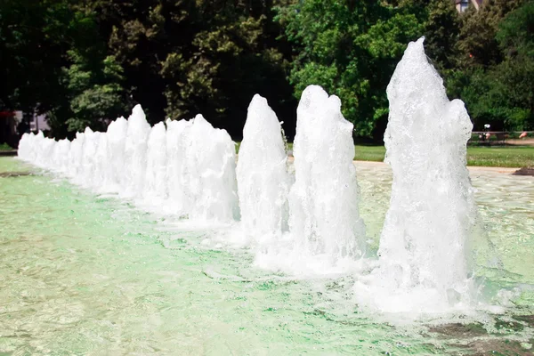 Fountains in a row in a city park. — Stock Photo, Image