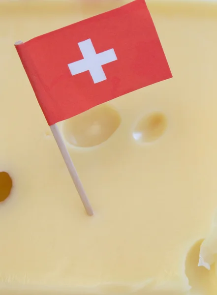 stock image Swiss flag on emmenthal cheese