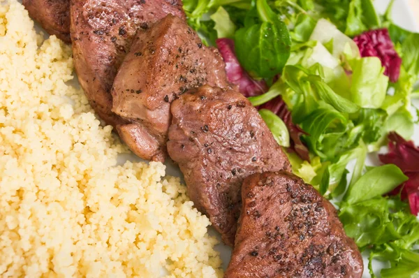 Tenderloin steaks in wine sauce with cadamon and kuskus groats — Stock Photo, Image