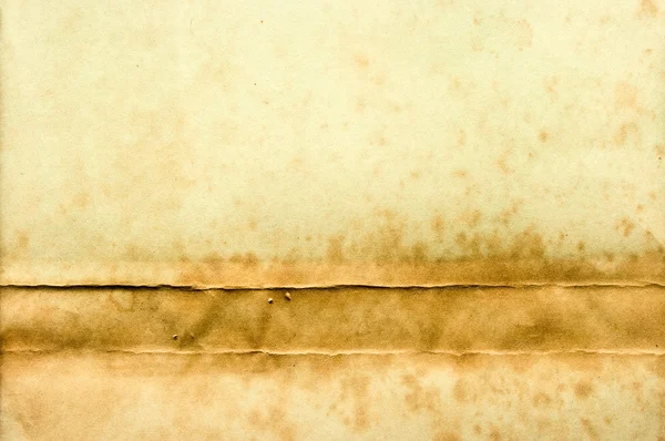Old yellow paper with stain on the bottom — Stock Photo, Image
