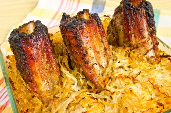 Stock image Spare ribs baked in sauerkraut