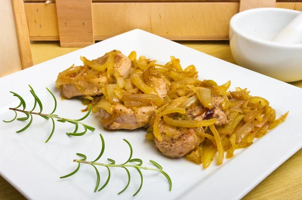 Pork sirloin steaks under onion — Stock Photo, Image