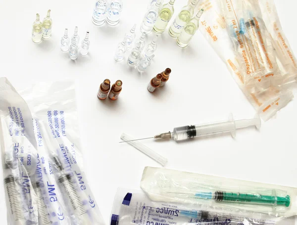 Blue ampules and syringe isolated on white background. — Stock Photo, Image