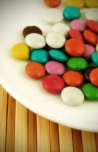 stock image Sweet coloured candy beans on bamboo mat