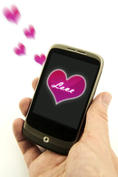 Ruka drží telefon s valentine love message — Stock fotografie