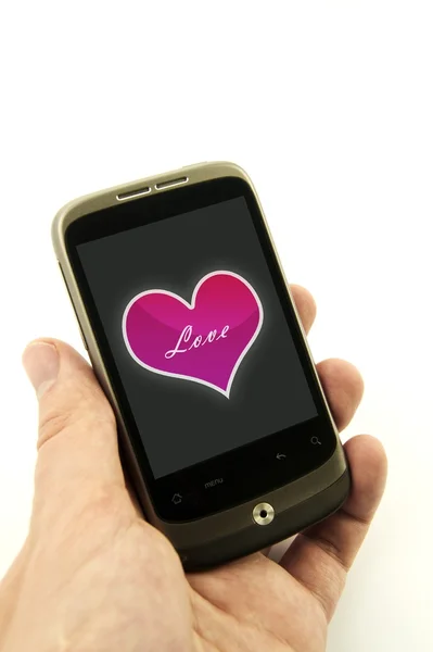 Hand holding phone with valentine heart — Stock Photo, Image