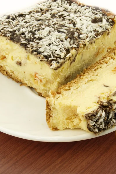 stock image Cheesecake with coconut on white plate