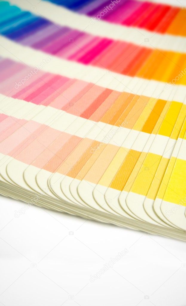 Pantone swatches book open showing an array of rainbow colours
