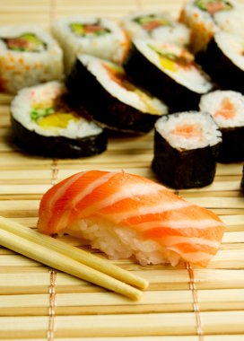 Japanese sushi. Tuna, sticks on bamboo napkin clipart