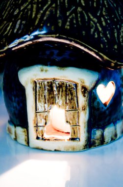Candle in the ceramic house clipart