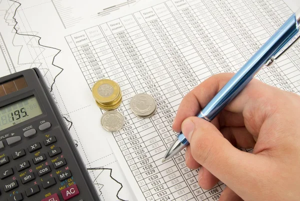 Calculator, coins and pen on a business background — Stock Photo, Image