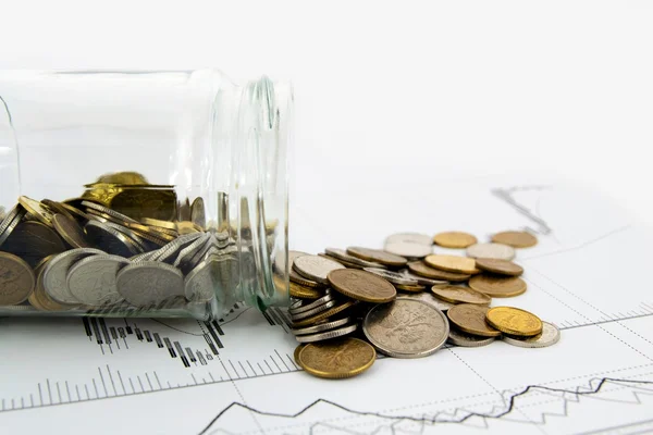 Coins Spilled From Jar on business background — Stock Photo, Image