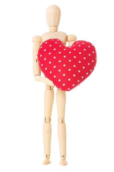 Wooden doll holds heart — Stock Photo, Image