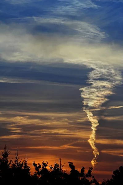 Sunset with contrail — Stock Photo, Image
