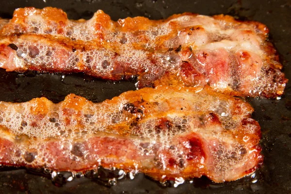 Bacon on raclette grill — Stock Photo, Image